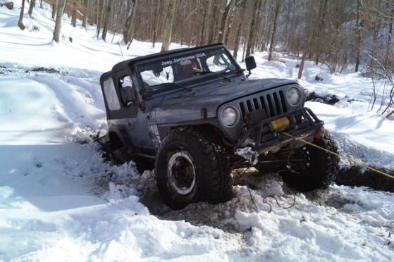 Jeep being pulled out of rut